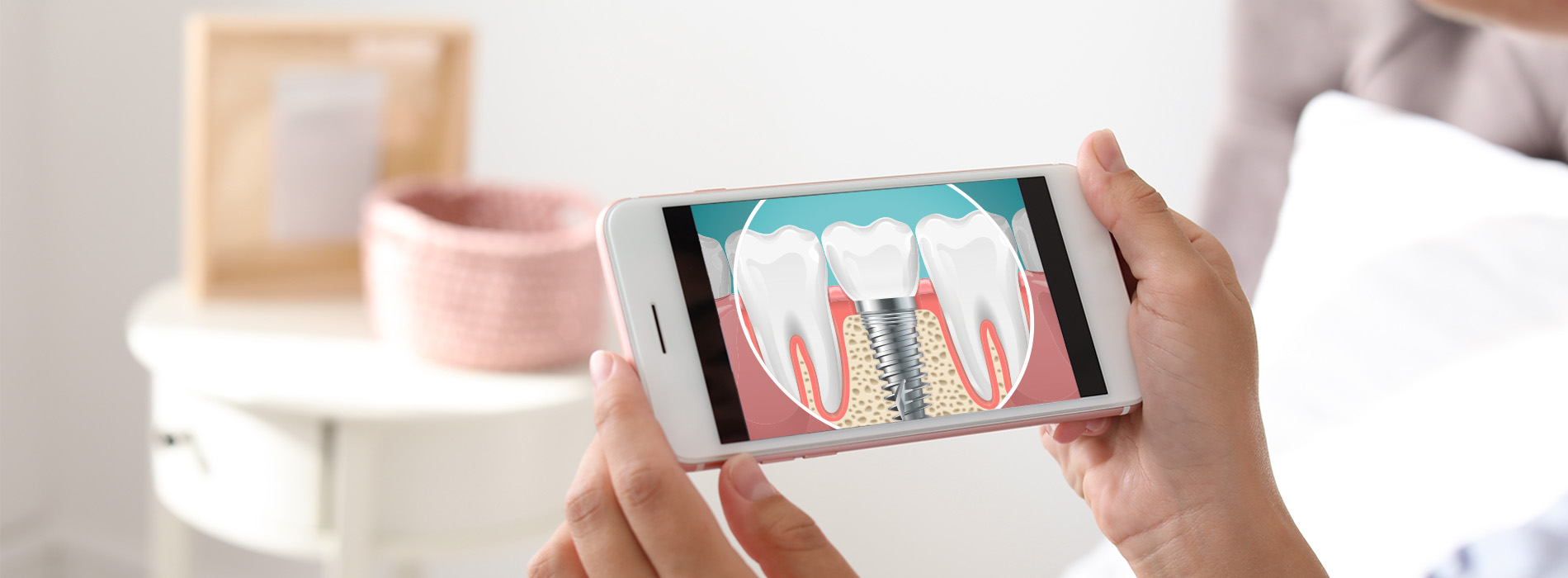 A person s hand holding a smartphone displaying an animated toothbrush cleaning teeth within a mouth.