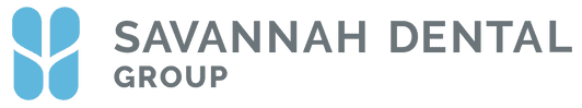 The image shows a logo with text that reads  Savannahh Dental  at the top, followed by the name  Savannahh Dental Group,  and below that, a phone number. The logo features a stylized letter  S  in blue and an abstract design resembling a smile or teeth in white. The background is gray with a subtle texture.