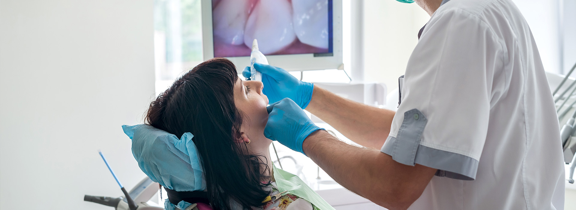 A dental hygienist assisting a patient during a dental appointment.