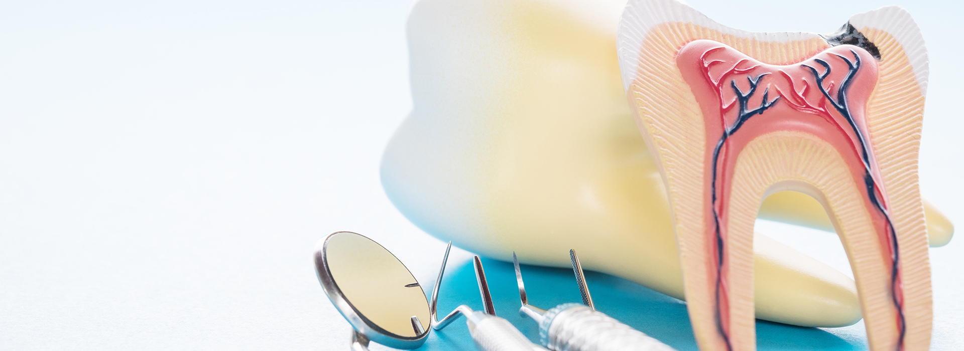 The image shows a close-up of dental tools including a toothbrush, toothpaste, and dental floss, with a focus on oral hygiene.